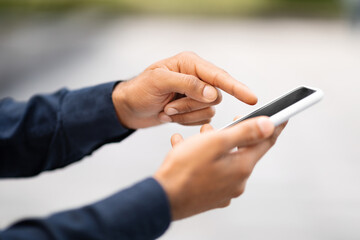 Cropped of man hands using phone with empty black screen