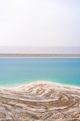 Desert landscape of Dead Sea coastline with white salt in Jordan