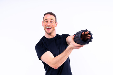 Athletic man using a foam roller to relieve sore muscles after a workout.