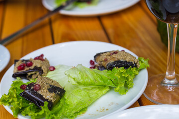 Eggplant roulade stuffed with walnuts and pomegranate fruit. Georgian appetizer.