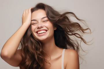 Charming Asian teenager with wavy long hair blowing in the breeze exudes positivity with a bright smile on a solid background. Generative AI.