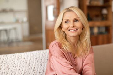 Portrait Of Beautiful Blonde Mature Lady Smiling Looking Aside Indoor