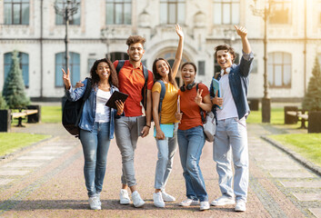 Studentship Concept. Group Of Happy Multiethnic Students With Workbooks Posing Together Outdoors