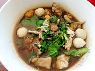 Delicious thin noodles with mixed pork meatballs and vegetables.