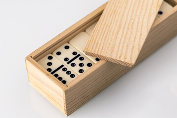 domino tiles stacked in a wooden box