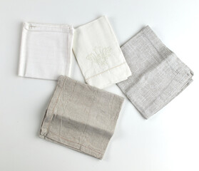 Napkins and towels on white background. Kitchen textiles, top view