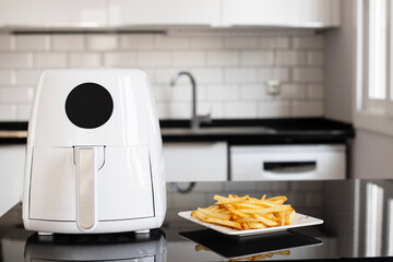Air fryer machine cooking potato fried in kitchen. Lifestyle of new normal cooking.