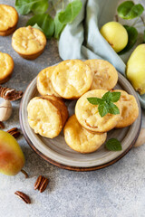 Autumn vegetarian baking. Homemade sweet cottage cheese muffins with pear stuffing, cinnamon and pecan on a stone tabletop. Copy space.