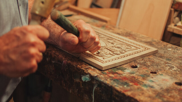 Man carving wooden furnitures