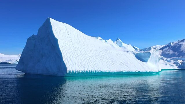 Boat excursion near icebergs of Kangia Fjord and Sermeq Kujalleq glacier in Ilulissat, Greenland.
