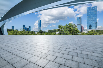 Empty square floor and city skyline with modern buildings background