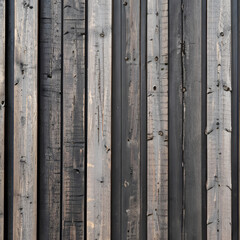 vertical dark brown black gray weathered wood house siding, thin small boards, texture, wooden texture, Ai generated 