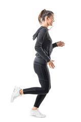 Happy smiling female jogger running in zip up hooded sweatshirt and leggings. Side view. Full body length isolated on transparent background.	
