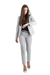 Young businesswoman checking hand watch walking forward in the rush. Full body isolated on transparent background.
