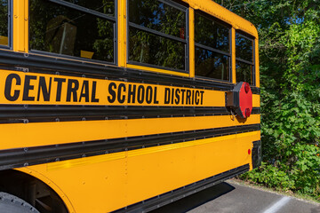 Side of a parked yellow school bus 