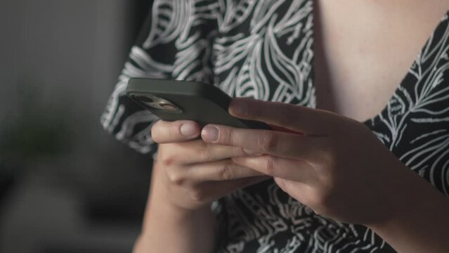 close up on hands of unknown caucasian woman use mobile phone smart phone for texting send text messages or browse internet online post on social network