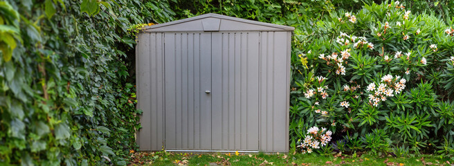Gardening tools storage shed in the house backyard