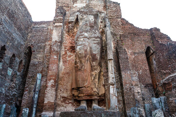 A giant masoned standing Buddha statue without head in a temple in the royal ancient city of...