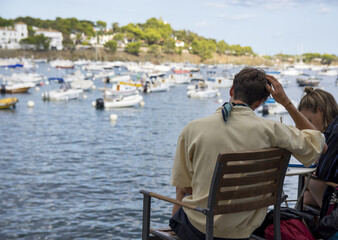 Fototapeta premium Back view unrecognizable of tourist looking at a village on holidays, lifestyle.