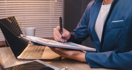 office a businessman focus on their work. With pens, notebooks, and notepads in hand, they...
