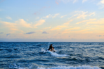 Fototapeta premium ride a jet ski on the beach, sunset over the sea, sunset in the sea, sea and sky, sunset over sea, beautiful sunset sky, blue and orange sky, sunset wallpaper