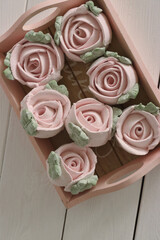 Marshmallow flowers on trays. Homemade zephyr. Close-up. View from above.