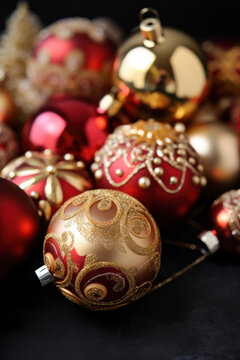 Red and gold Christmas ornaments in a festive pile 