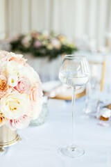 Amazing wedding table decoration with flowers. Beautiful flowers decorated on the table.Tables set for an event party or wedding reception. luxury elegant table setting dinner in a restaurant. 