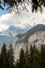 Swiss Alps in Switzerland in the Summer With Mountains Peaking Through the Clouds in the Background