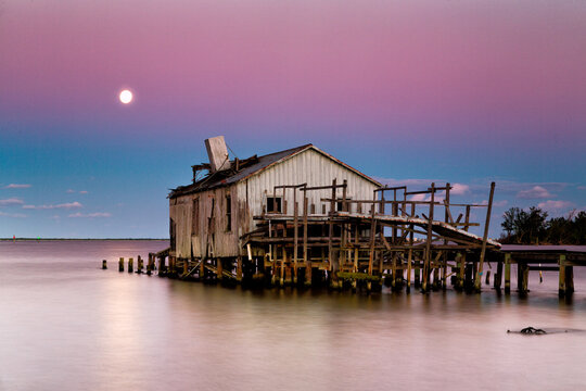 Old Archie Smith fish house with full moon, Sebastian, Florida.