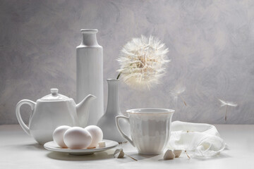 White still life with white dishes on a white background