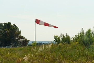 A red and white wind cone indicating the direction and strength of the wind