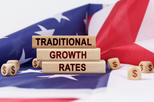 On the US flag and wooden plates with the inscription - traditional growth rates
