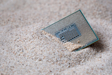CPU or Micro Processor Unit on the sand. Semiconductor component buried in the ground. 