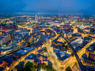 Leeds, West Yorkshire, England. Leeds city centre aerial view looking over the river Aire towards the city, Bridgewater place and Leeds train station at night