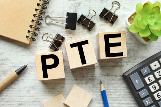 pte - text on wooden cubes stationery. foreground