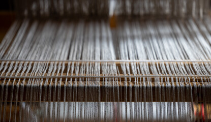 Close-up of ancient traditional hand weaving loom or weaving machine, selective focus