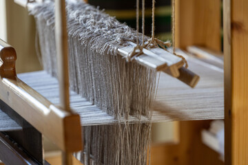 Close-up of ancient traditional hand weaving loom or weaving machine, selective focus