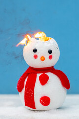 A toy snowman is on fire. Fire for the new year