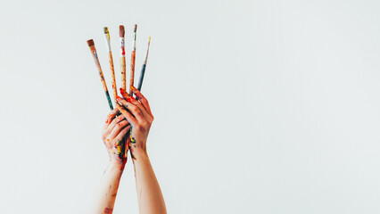 Art brush. Drawing course. Woman painter hands holding set of messy oil paint colorful kit of...