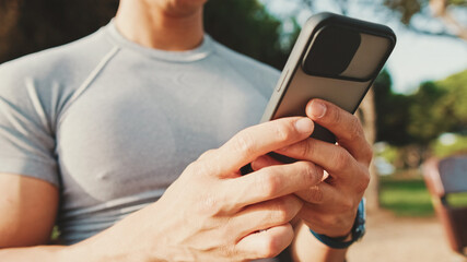 Close-up of the hands of an unrecognizable young man using a mobile phone