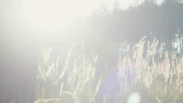 Athletic caucasian girl stretching in a wheat field after work out, athlete sport recreation post-workout recovery