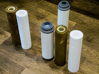 Used water filters with traces of dirt, clay and impurities and clean filters, prepared for...