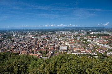 Fototapeta na wymiar Freiburg im Breisgau. View over the roofs of the old town with Freiburg Cathedral. Baden-Wuerttemberg, Germany, Europe