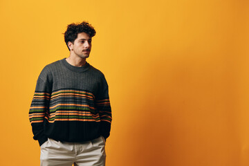Man fashion happy sweater modern gesture trendy student smile background portrait orange