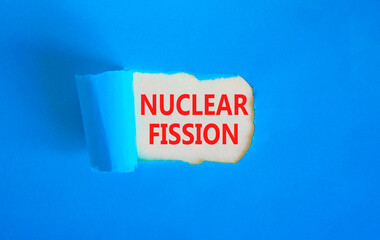 Nuclear fission symbol. Concept words Nuclear fission on beautiful white paper. Beautiful blue...