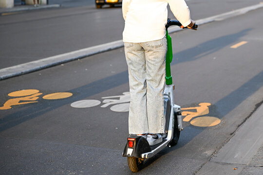 Illustration picture shows people using self-service electric scooters (here a E-scooter of the company "LIME Micromobility" or "On Lime + Uber") in streets of Paris, France on August 8, 2023.