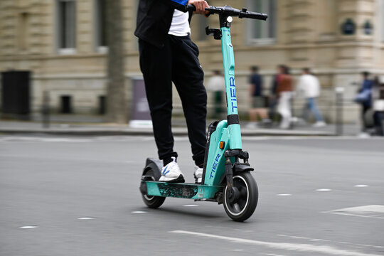 Illustration picture shows people using self-service electric scooters (here a E-scooter of the company TIER) in streets of Paris, France on August 8, 2023.