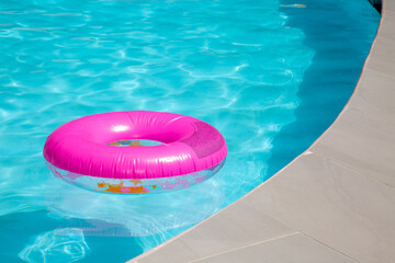 Pink inflatable innertube floating in a pool