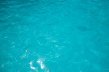 Pool water, cool blue, filling the entire frame. High resolution background or texture asset.